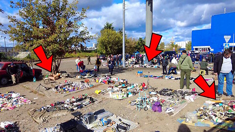 A unique flea market nestled amidst piles of refuse. An enchanting marketplace