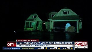 Halloween-themed videos projected on house