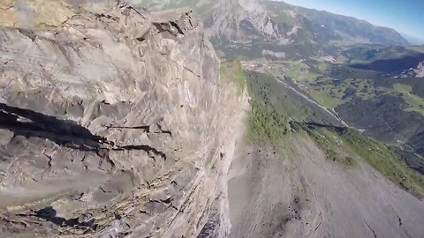 Wingsuit pilot jumps from mountain's edge