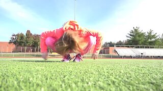 Jackie Kid somersaults into the Camera on Football Field