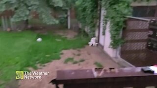 Lightning flashes as hail pings around backyard deck