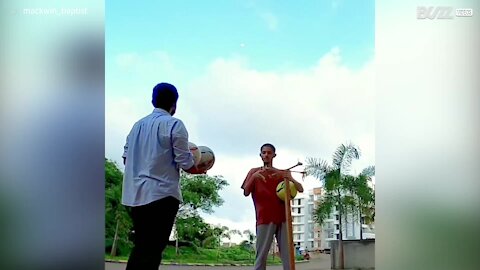 Juggler balances four balls at the same time