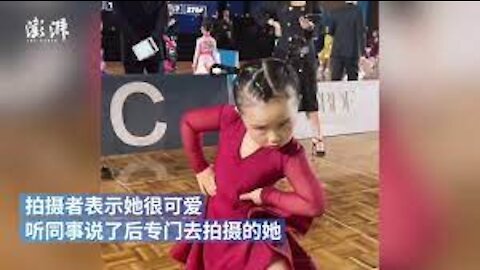 Little Chinese girl dances in competition with strong passion and determination