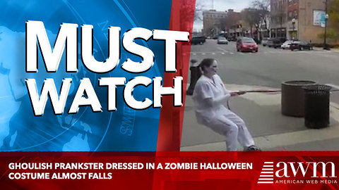 Ghoulish prankster dressed in a zombie Halloween costume almost falls