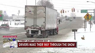 Drivers make their way through the snow