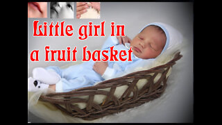 Little girl in a fruit basket