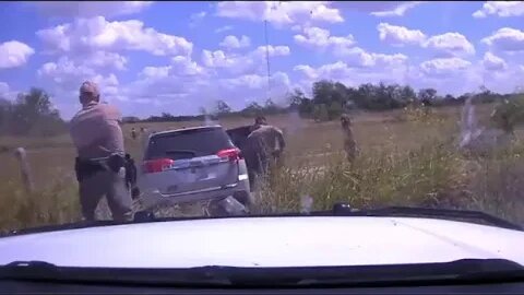 A human smuggler crashes his vehicle and bails out with a group of illegal immigrants.