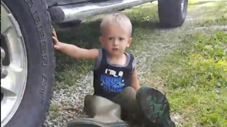 Little Boy Tries On Dad's Boots