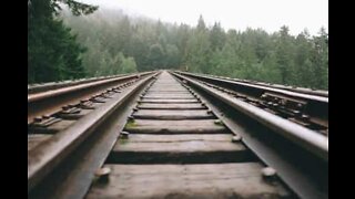 Man lays on train tracks and survives speeding train
