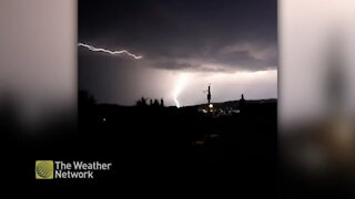 Huge bolt of lighting forks across the night sky