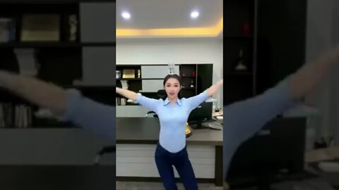 Pretty Chinese Girl Balances A Cup Of Water On Her Head While Dancing