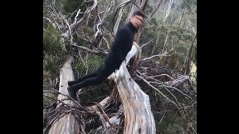 Guy Does A Flip Over A Log With Hands In His Pocket