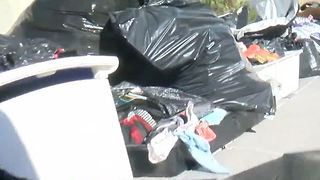 Massive trash pile sits in driveway for weeks, upsetting neighbors