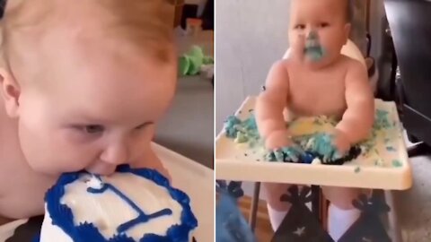 Toddler destroying cake on first birthday