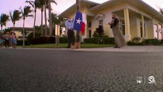 Fort Pierce neighbors give flag-waving surprise to young man with special needs