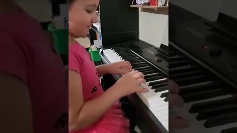 8 year old filipino-american girl playing the piano as a pipe organ as she plays, "Oh Holy Night."