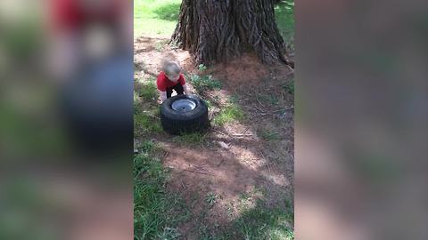 Tot Boy Helps His Father To Change A Broke Tire