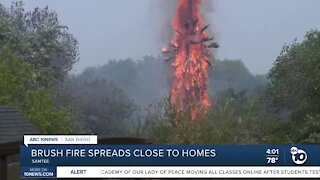 Brush fire spreads close to homes