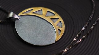 Making a silver and gold moon necklace by hand