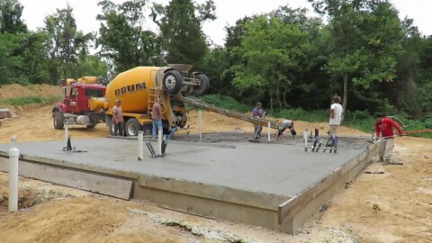 Pouring the concrete floor for our Rustic cabin in the woods building project!