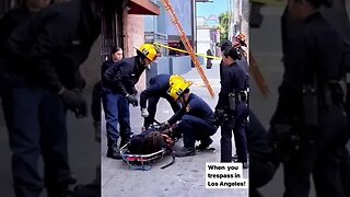 Homeless guy climbs on to roof a local business and refuses to get down.