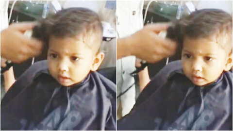 Serious or funny baby boy haircutting