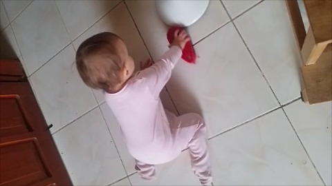 Baby helps mommy with household chores