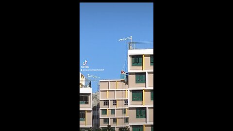 Construction Workers on the side of an Unfinished HDB Block in Singapore