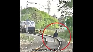 Unhinged man tries to block a train and gets smacked