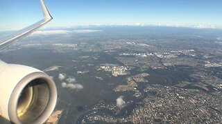 Qantas B737-800 landing at Sydney (city skyline view)