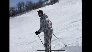 Dad skis in his hunting camo