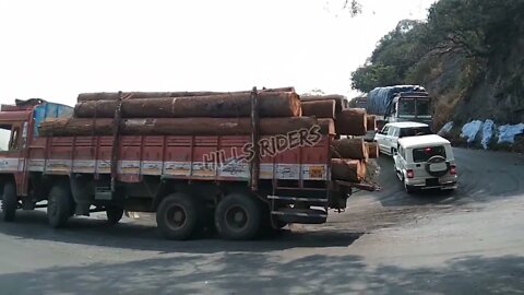 heavy wooden load truck struglled drive on dhimbam hills by talented skilled drive