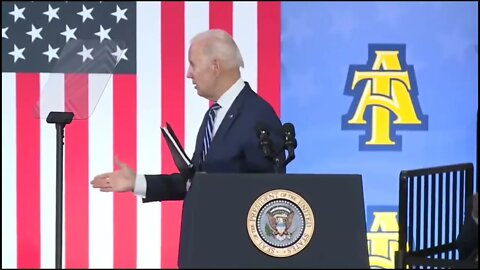 Biden shaking hand with no one.