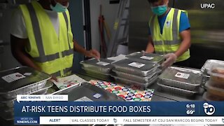 At-risk teens work to distribute food boxes for those in need