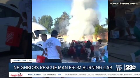 Neighbors rescue man from burning car