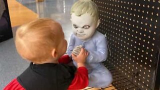 Toddler not spooked by creepy Halloween dummy