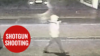 Man walking down a street holding a 'SHOTGUN,' moments before he was shot dead