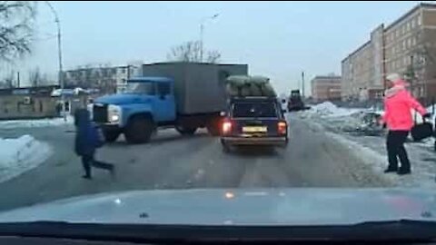 Child crosses street unexpectedly, almost gets hit by truck