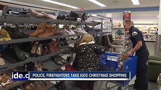 Police, firefighters take kids Christmas shopping