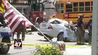 Woman dies after car hits school bus in Jackson