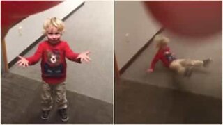 Dad knocks down his kid with a giant ball