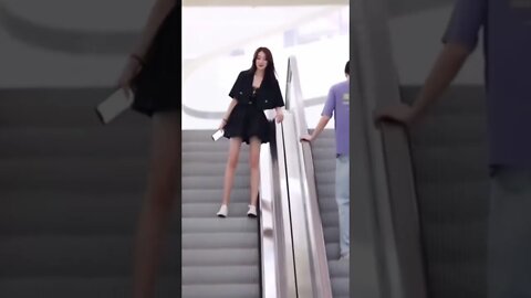 Chinese Girl Makes A Play On An Escalator
