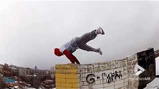 Guy handstands on frozen ledge
