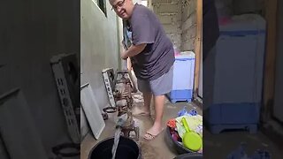 OLD FOREIGN GUY PUMPING WATER IN PHILIPPINES PROVINCE