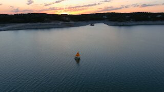 Drone Video of a Sailboat Sailing at Sunset on Medina Lake in Texas