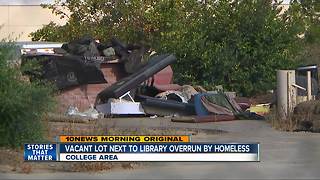 Residents frustrated by homeless garbage left on vacant lot near library