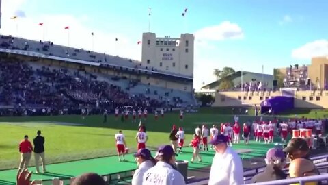 Northwestern University Wildcats put their hands up in the air at a football game