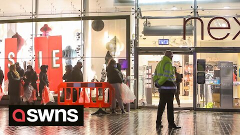 Shoppers queue around the block as Next opens for its Boxing day sale