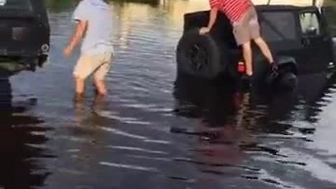 Cars getting towed out of flooded areas in Fort Myers on Island park Rd