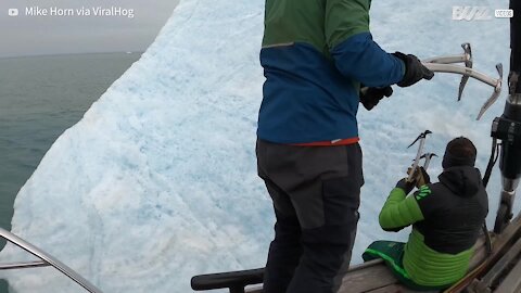 Iceberg turns upside down while explorers were climbing it